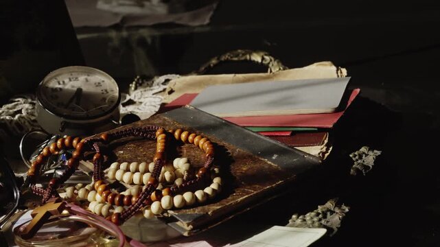 A crucifix necklace rests among treasured personal belongings, suggesting faith, memory, family heritage, and the emotional significance of objects preserved through time.