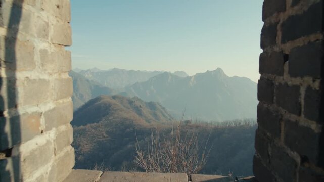 Framed View of Hazy Mountain Ranges Seen Through the Stone Archway of an Ancient Great Wall Watchtower