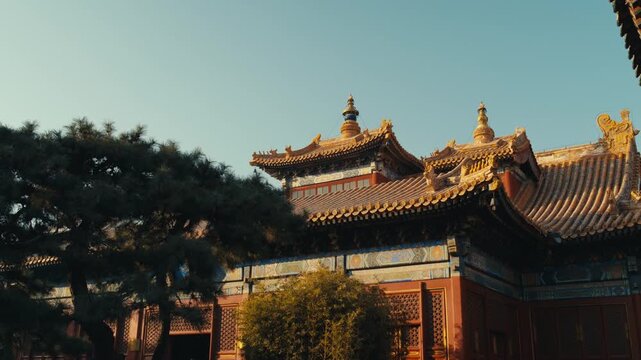 Beijing Yonghe Lama Temple: Architectural Detail of Ornate Imperial Pavilions with Tiered Golden Roofs, Finials, and Traditional Polychrome Friezes at Sunset