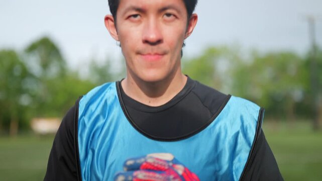 Confident young soccer player stands ready for outdoor training, displaying physical strength, exceptional football skills, determination, focus, and athletic excellence while preparing to achieve.