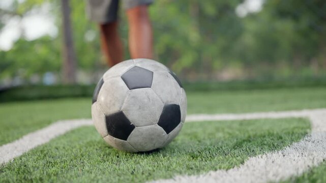 Professional footballers prepare for training on an outdoor field, setting up the ball for a corner kick. Strength, speed, technical precision and passion are all emphasized while preparing for matche