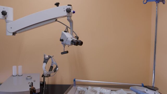 Professional medical surgical microscope and sterile instruments in a clean clinic setting. Suitable for healthcare, advanced surgery, and biotechnology content.