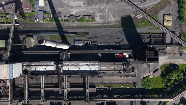 Aerial drone view of Kokerei Schwelgern in Duisburg, showing coke ovens, coal processing, chimneys and steel industry infrastructure.