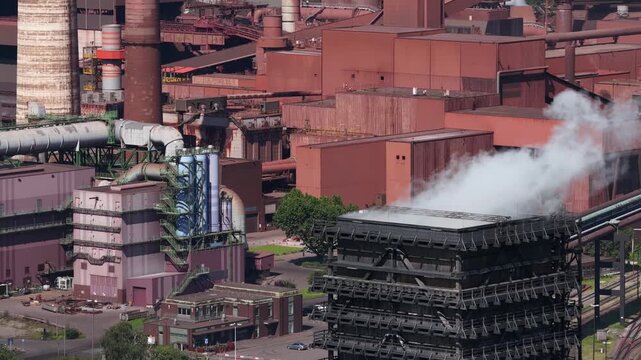 Aerial drone view of Kokerei Schwelgern in Duisburg, showing coke ovens, coal processing, chimneys and steel industry infrastructure.