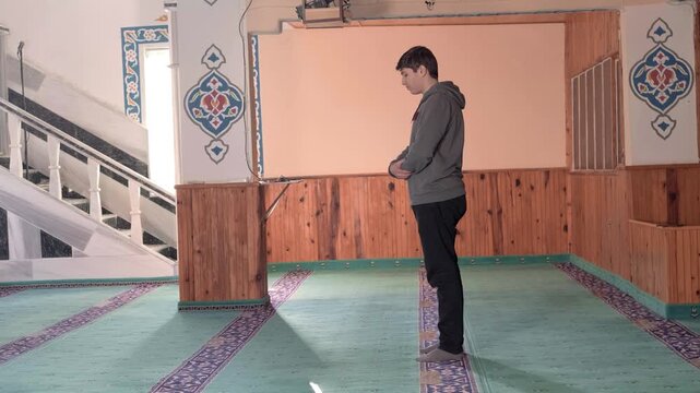 Young man praying mosque