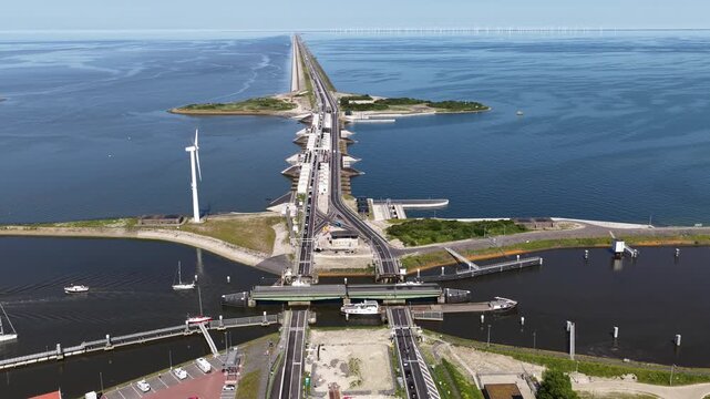 Aerial drone view of the Stevinsluizen at Den Oever, showing lock infrastructure, shipping access and water discharge between the IJsselmeer and Wadden Sea.