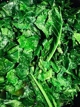 A pile of cooked spinach studded with salt