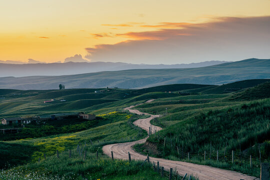 Rolling alpine grassland hills at sunset, Ili Xinjiang China