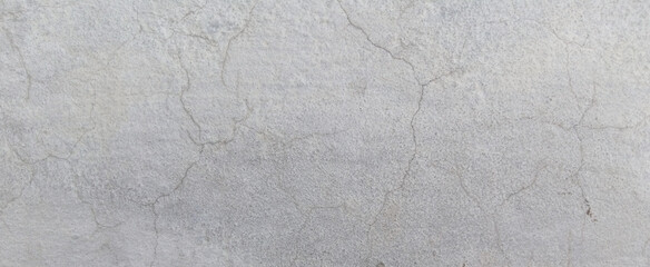 Fototapeta premium Weathered concrete texture with fine cracks, industrial gray cement wall background, distressed stone surface for architectural design and overlays