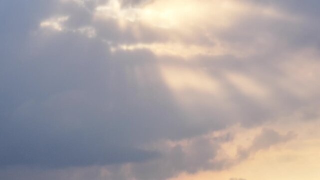 Tilt-up view of dramatic storm clouds illuminated by sunset light above Walensee, Switzerland, atmospheric alpine weather scene view.
