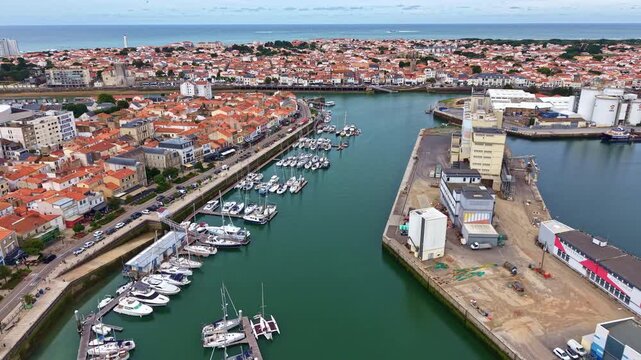 Sailboats docked at marina in Les Sables-d'Olonne, France. Aerial drone backward