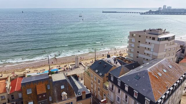Promenade Georges Clemenceau with Horloge Pendule des Sables, clock tower and beach in Les Sables-d'Olonne, France. Aerial forward