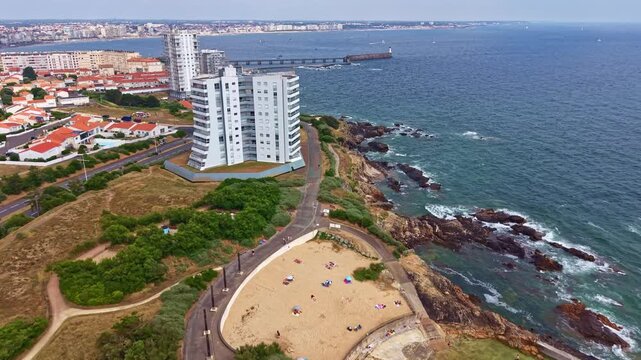 Aerial view of coastal buildings, rocky shoreline, and jetties by the Atlantic Ocean, Sables d&rsquo;Olonne