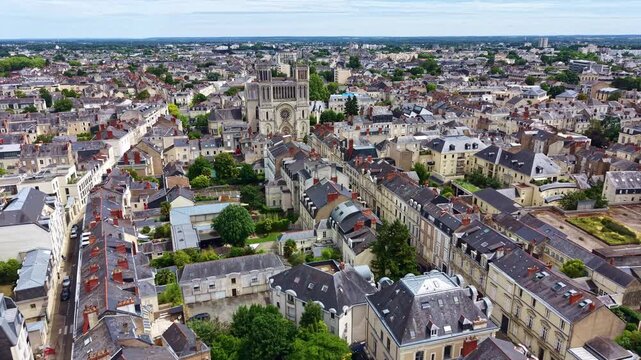 Angers cityscape with Saint Joseph church in background, France. Aerial drone forward