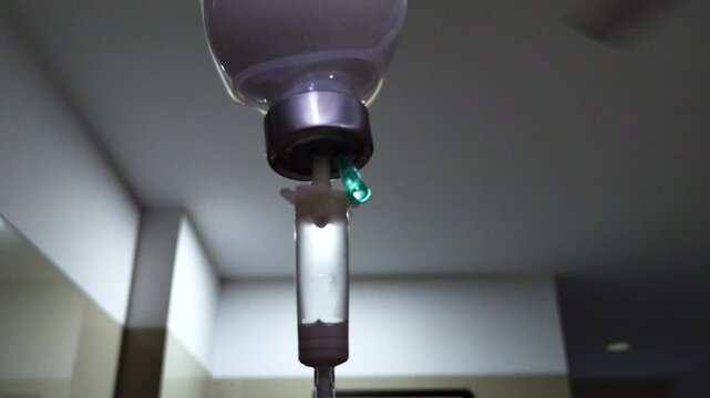 Detailed close-up of intravenous infusion equipment in healthcare facility. Ideal for medical treatment, hospitalization, patient care, recovery, and clinical healthcare concepts.