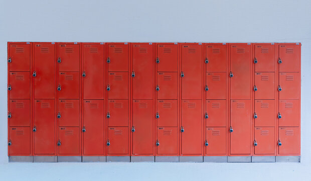 Orange metal lockers in rows with security padlocks