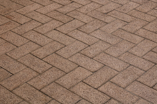 Brown herringbone paving block floor or walkway surface.