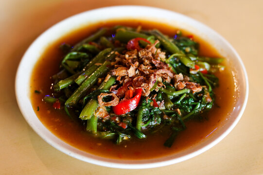 A plate of Stir-Fried Water Spinach with Shrimp Paste (Kangkung Belacan).