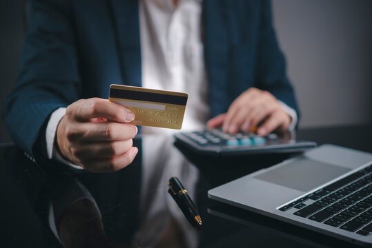 E-commerce and digital banking concept. Executive holding credit card for internet purchase or expense accounting.
