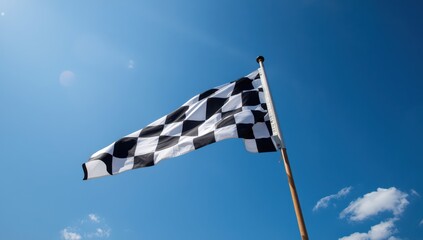 Naklejka premium Outdoor low-angle view of a checkered flag in a blue sky. Room for text.