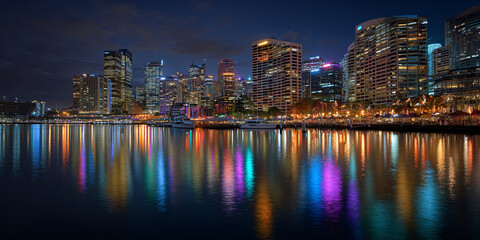 Fototapeta premium City Bay Skyline with Boats Reflecting at Night