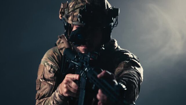 Armed combat soldier aiming rifle while wearing modern tactical gear. Concept military strength, combat operations and security.
