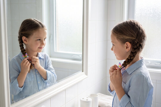 Girl Buttoning Shirt at Bright Window Getting Dressed Morning