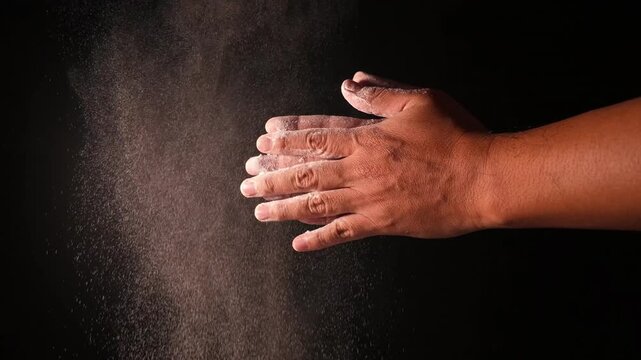 Hands Clapping Flour Powder Creating Dust Cloud in Slow Motion