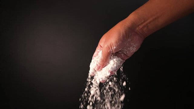 Hand Sprinkling Flour in Slow Motion for Baking Preparation