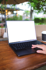 Fototapeta premium Vertical mockup image of a woman working and touching on laptop computer touchpad with blank white desktop screen in cafe