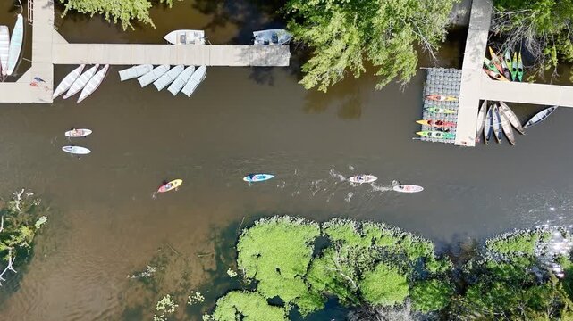 Aerial view of kayak docks and riverside recreation area surrounded by lush forest in Montreal, Canada. g.