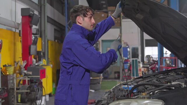 Automotive specialist conducting vehicle maintenance in a well equipped garage setting