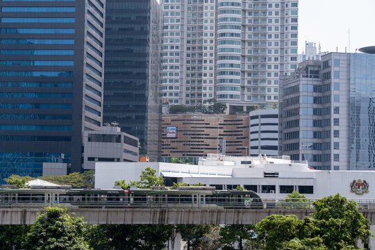 Jakarta, Indonesia - May 21, 2026: An LRT Jabodebek train featuring a special "80 Tahun Melayani" anniversary livery traveling on an elevated track in Kuningan, Jakarta.