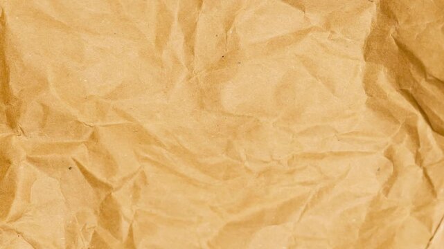 Crumpled Brown Kraft Paper Texture Background. Detailed Macro Shot of Wrinkled Packing Paper with Deep Creases and Folds