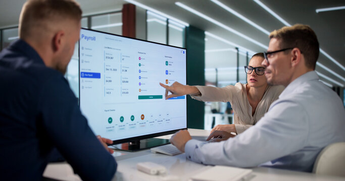HR Manager And Team Using Payroll Software