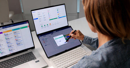 Woman Using Laptop To Review Candidate Profiles