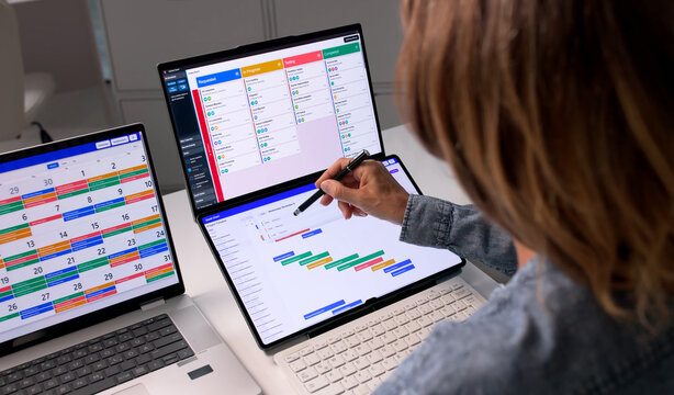 Agile Project Manager Updates Task List On Laptop