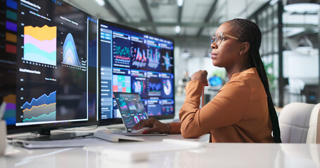 Young Financial Analyst Using Laptop