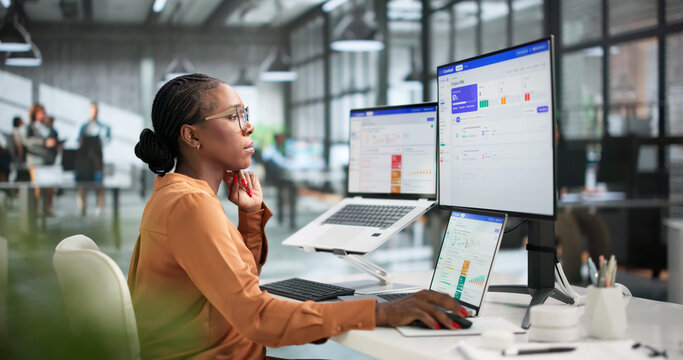 Young Business Analyst Reviews Quarterly OKR Dashboard
