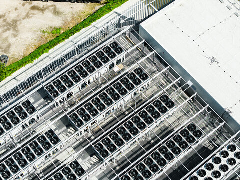 Aerial view of the EU North Riga LV DC1 data center roof featuring rows of industrial cooling fans and ventilation systems in Riga, Latvia.