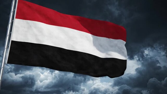 Flag of yemen waving against a dramatic stormy sky background