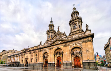 Naklejka premium View of the neoclassical facade and towers of the Metropolitan Cathedral of Santiago located in the historic center of Chile.