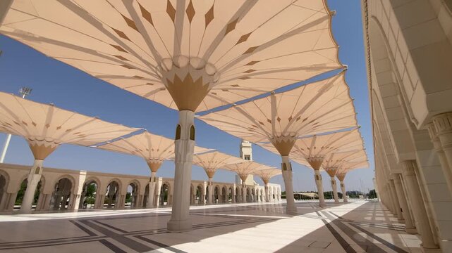 Automated umbrellas rise gracefully in the courtyard of Sheikh Khalifa Bin Zayed Al Nahyan Mosque, blending modern utility with sacred elegance.