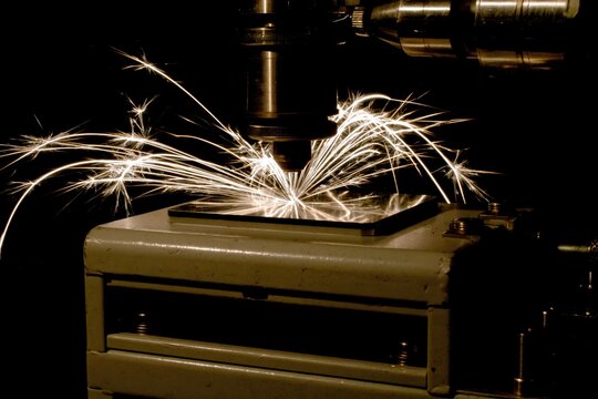 Industrial metal cutting with spark generation in a mechanical workshop or factory setting