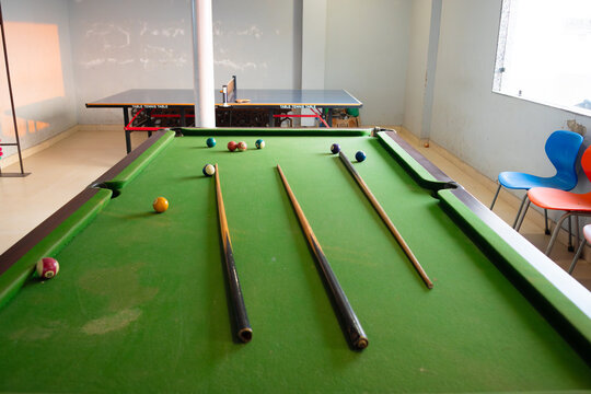 billiard table with cue and ball