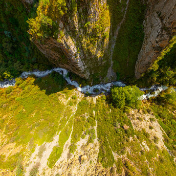 Aerial View of a Mountain Gorge with a Rushing River in Kyrgyzstan