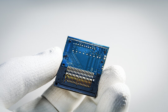 Hand holding microchip  in lab. Electronics repair, the offer for sale.
