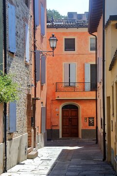 Traditional Italian alleyway and historic building facades in Modena, Emilia-Romagna, Italy