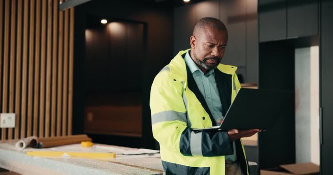 Laptop, renovation and serious with black man in kitchen for home improvement or upgrade project. Computer, real estate and research with mature construction worker in apartment for property update