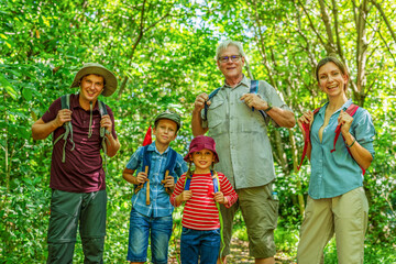 Fototapeta premium Family hiking in lush forest